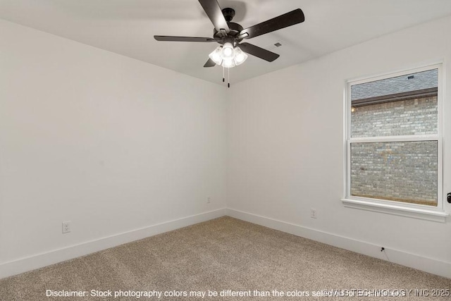 carpeted spare room with baseboards and a ceiling fan