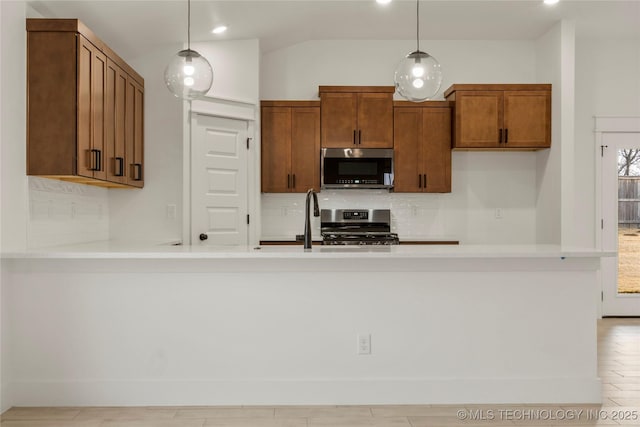 kitchen featuring stainless steel appliances, pendant lighting, plenty of natural light, and sink