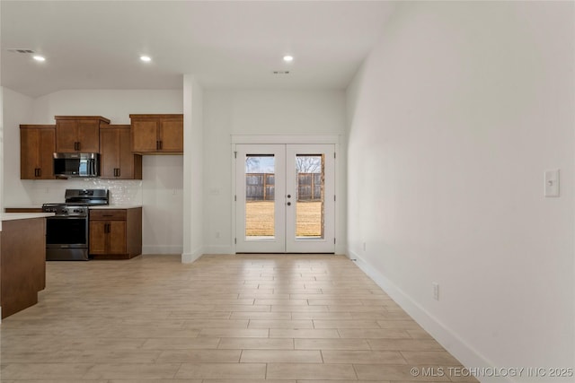 kitchen featuring tasteful backsplash, french doors, and stainless steel appliances