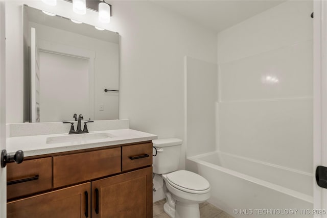 full bathroom featuring toilet, vanity, tile patterned flooring, and washtub / shower combination