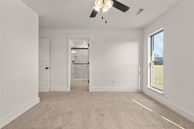 spare room with ceiling fan and light colored carpet