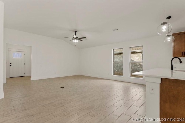 unfurnished living room with lofted ceiling, sink, light hardwood / wood-style floors, and ceiling fan