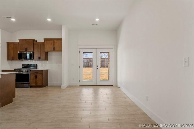 kitchen featuring appliances with stainless steel finishes, backsplash, and french doors