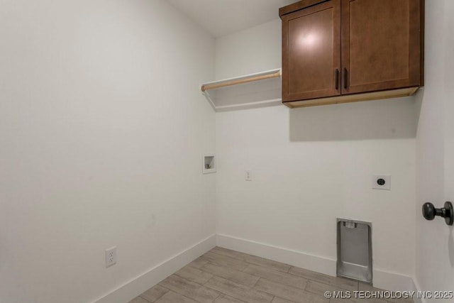 laundry room featuring washer hookup, cabinets, and hookup for an electric dryer