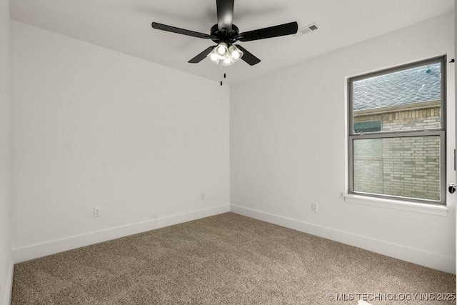 carpeted spare room with ceiling fan