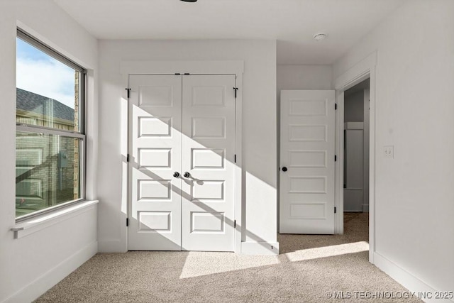 interior space featuring light colored carpet