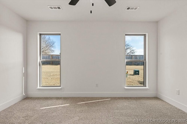 unfurnished room with carpet, a wealth of natural light, and ceiling fan