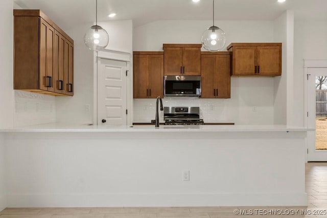 kitchen featuring sink, decorative light fixtures, and stainless steel appliances