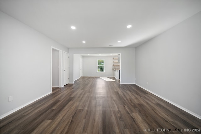 unfurnished living room featuring dark wood-type flooring