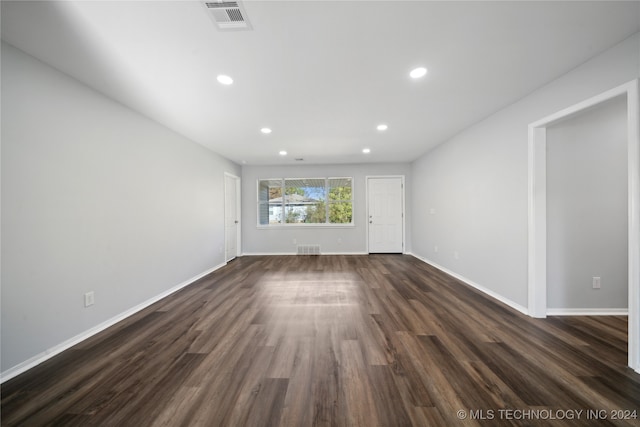 unfurnished living room featuring dark hardwood / wood-style floors