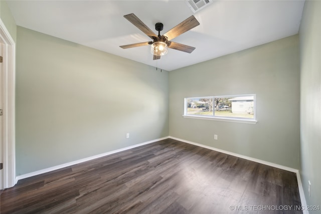 empty room featuring ceiling fan and dark hardwood / wood-style flooring