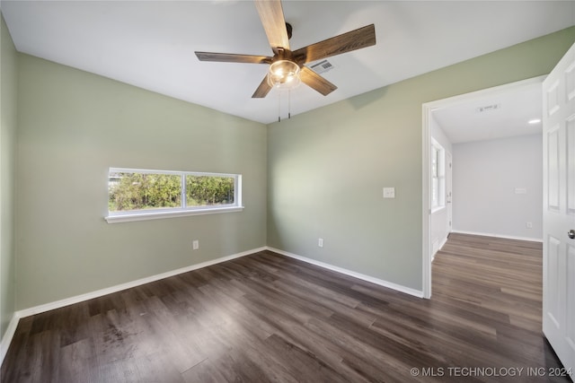 unfurnished room featuring dark hardwood / wood-style flooring and ceiling fan