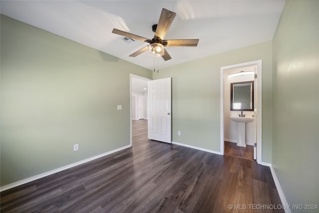 unfurnished bedroom with ceiling fan, dark hardwood / wood-style flooring, sink, and ensuite bath