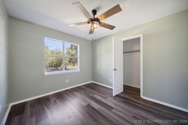 unfurnished bedroom featuring a closet, ceiling fan, and dark wood-type flooring