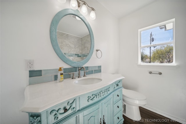 bathroom featuring toilet, vanity, and hardwood / wood-style flooring