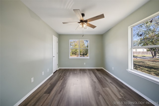 spare room featuring ceiling fan and dark hardwood / wood-style flooring