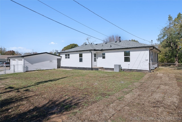 rear view of property with a yard