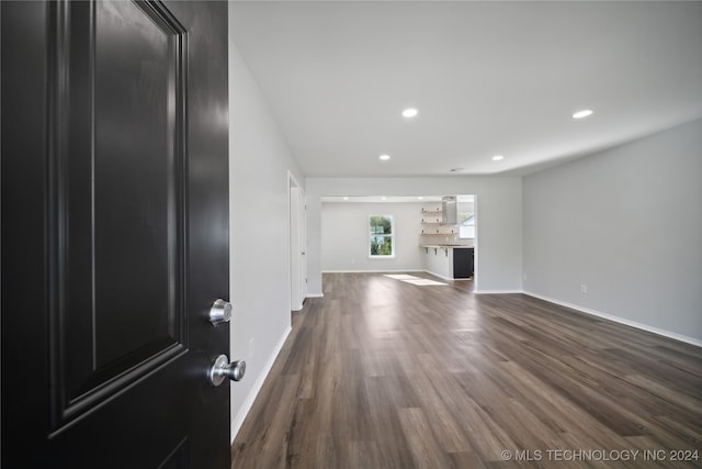 unfurnished living room featuring dark hardwood / wood-style flooring