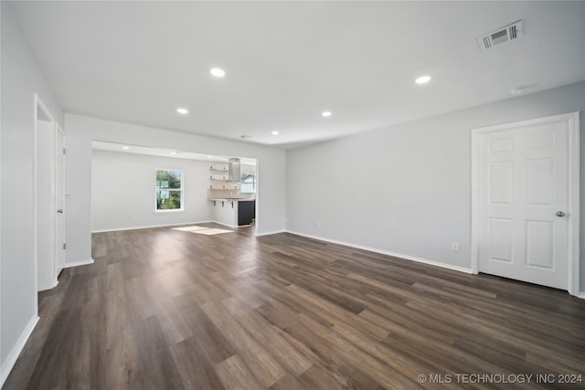 unfurnished living room featuring dark hardwood / wood-style flooring