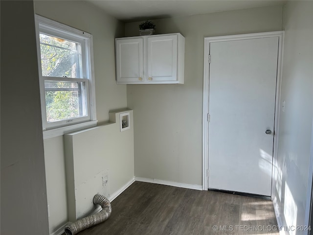 washroom with hookup for a washing machine, dark wood-type flooring, and cabinets