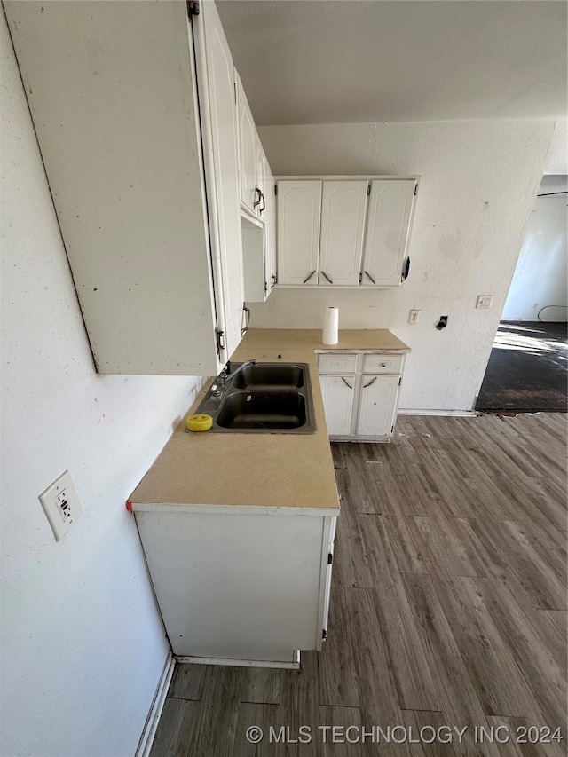 kitchen featuring sink, white cabinets, and dark hardwood / wood-style floors