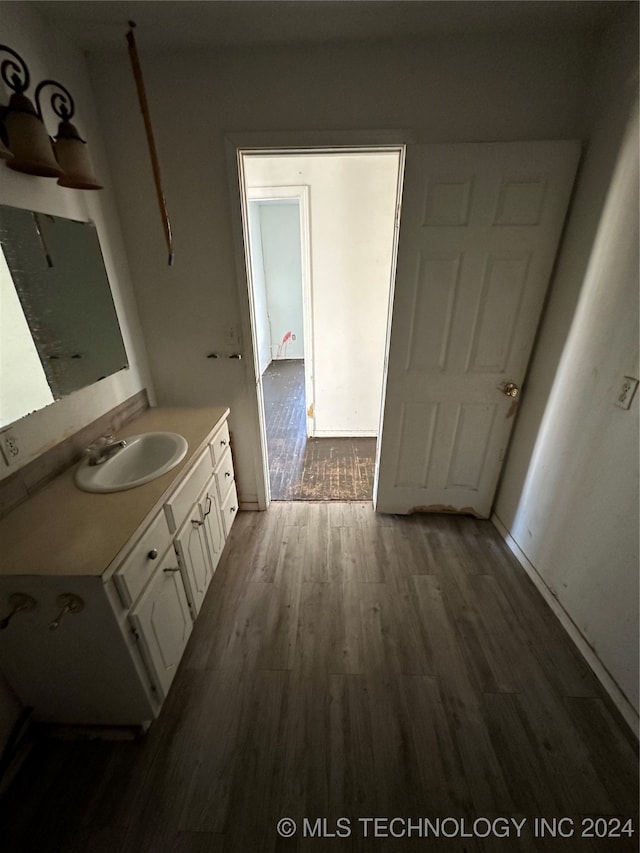 bathroom with hardwood / wood-style floors and vanity