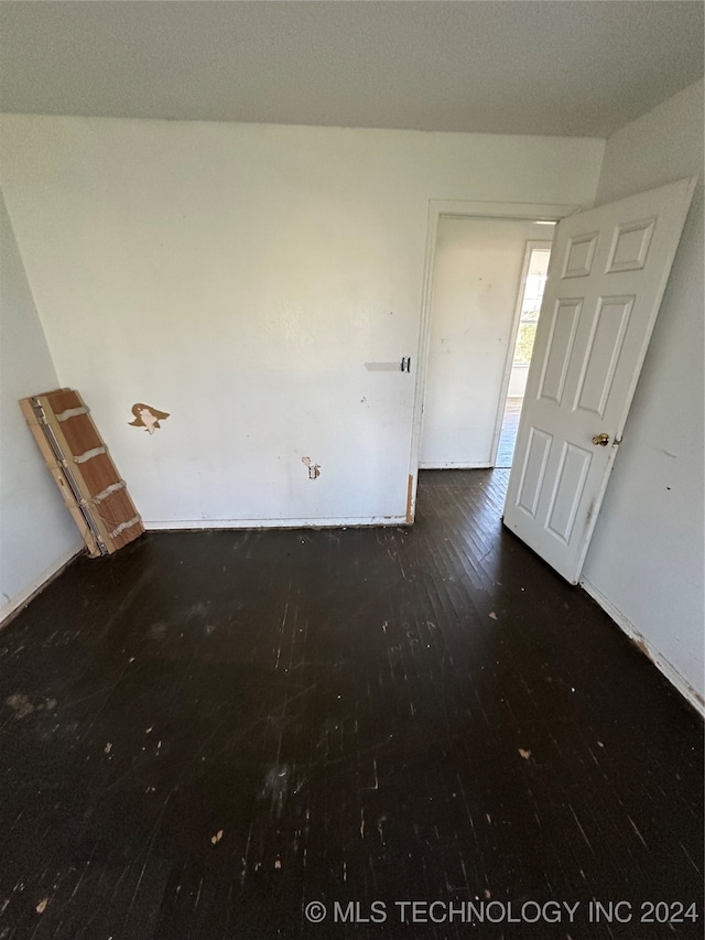 unfurnished room featuring dark hardwood / wood-style flooring