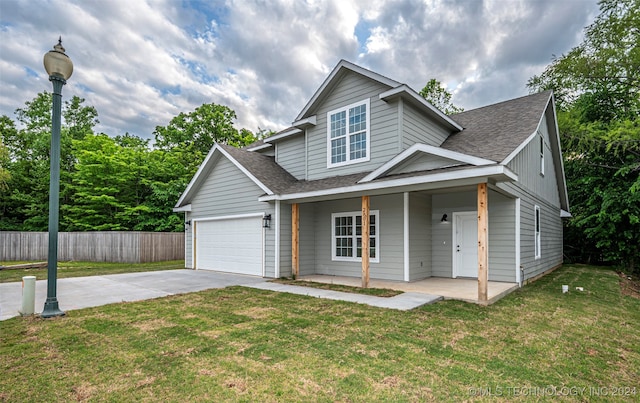 view of front facade featuring a front yard, a porch, and a garage