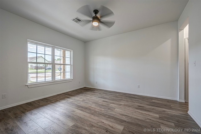 unfurnished room featuring ceiling fan and dark wood-type flooring