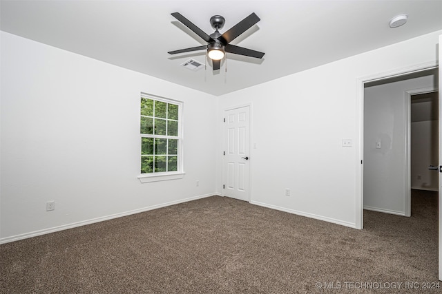 unfurnished room featuring dark carpet and ceiling fan