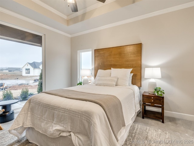 carpeted bedroom with a raised ceiling, crown molding, and ceiling fan