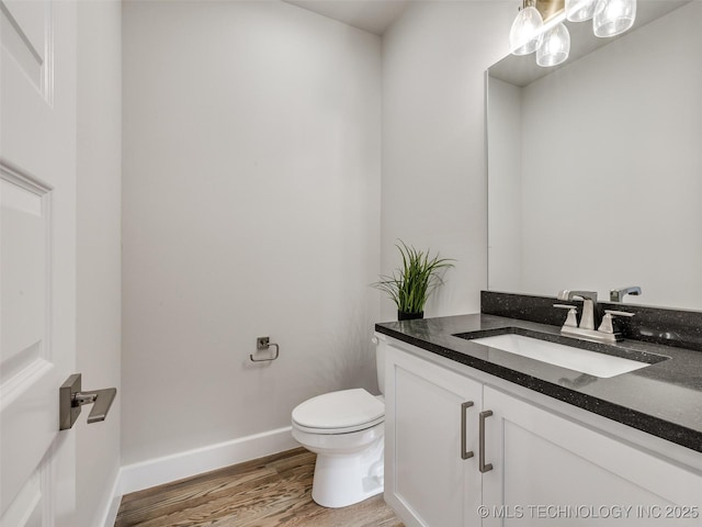 bathroom featuring vanity, toilet, and hardwood / wood-style floors