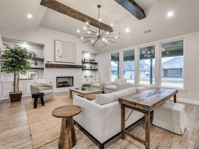 living room featuring vaulted ceiling with beams and light hardwood / wood-style floors