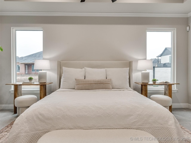 bedroom with crown molding, ceiling fan, and carpet