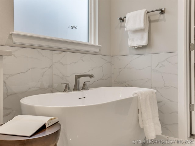 bathroom with sink and a tub to relax in