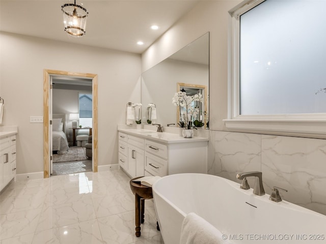 bathroom featuring vanity and a tub to relax in