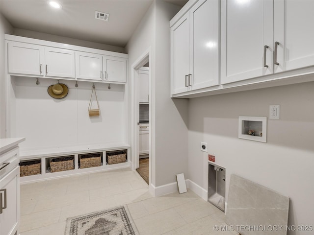 laundry area with hookup for a washing machine, hookup for an electric dryer, and cabinets