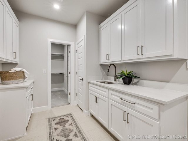 interior space featuring sink and white cabinets