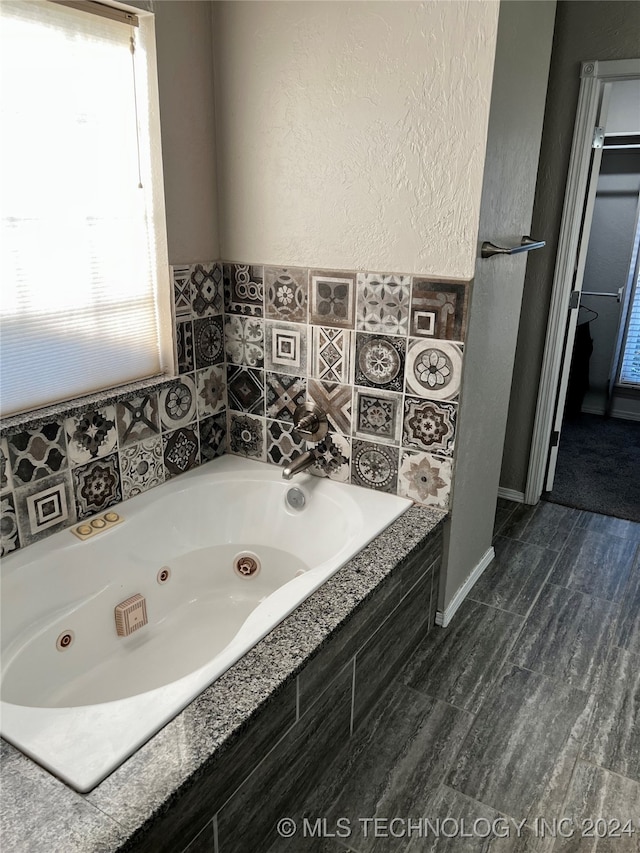 bathroom with tiled bath