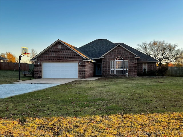 ranch-style home featuring a front lawn and a garage