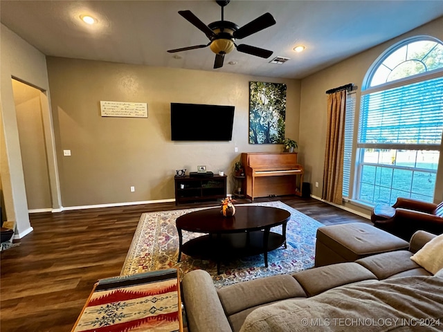 living room with ceiling fan, a healthy amount of sunlight, and dark wood-type flooring