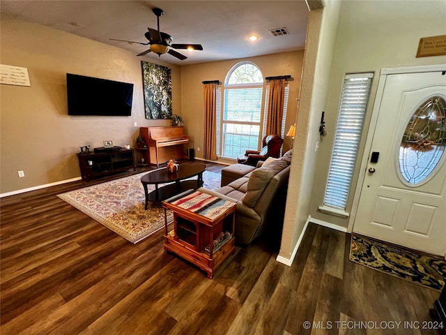 living room with dark hardwood / wood-style floors and ceiling fan