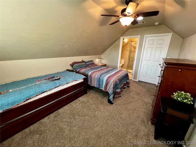 bedroom with carpet flooring, ensuite bathroom, vaulted ceiling, and ceiling fan