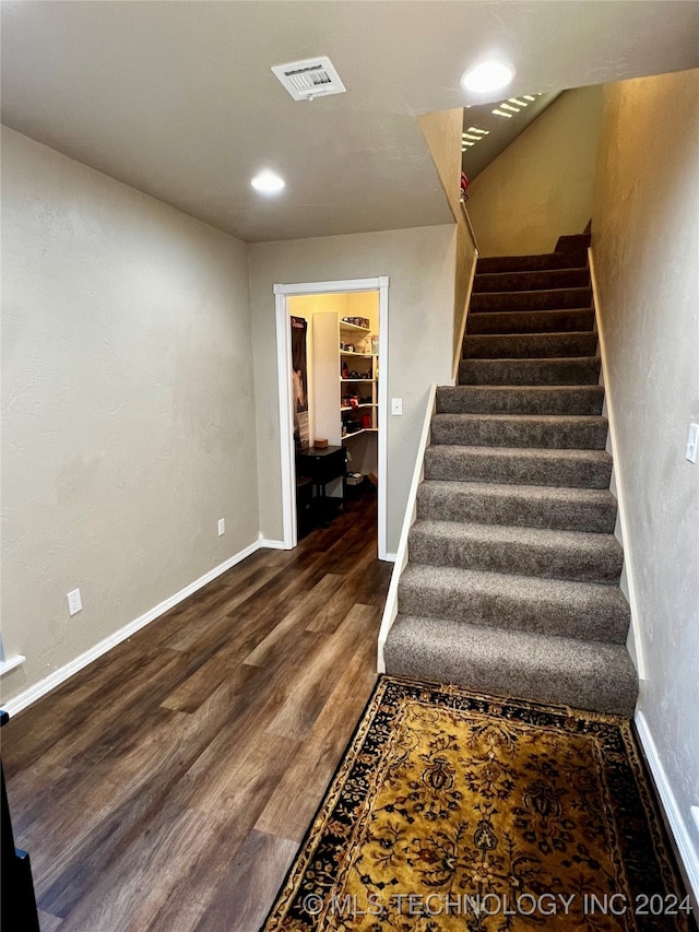 staircase featuring hardwood / wood-style flooring