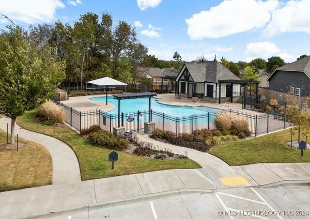 view of pool featuring a patio area and a yard