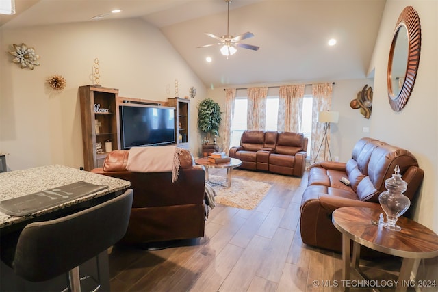 living room featuring ceiling fan, light hardwood / wood-style flooring, and high vaulted ceiling