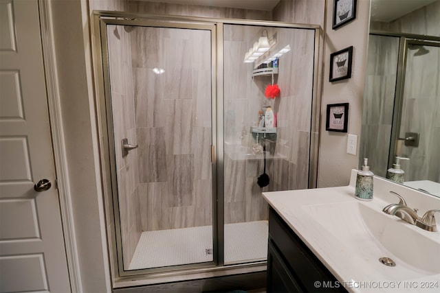 bathroom featuring vanity and a shower with shower door