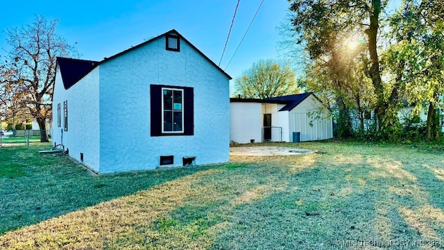 view of side of property with a lawn