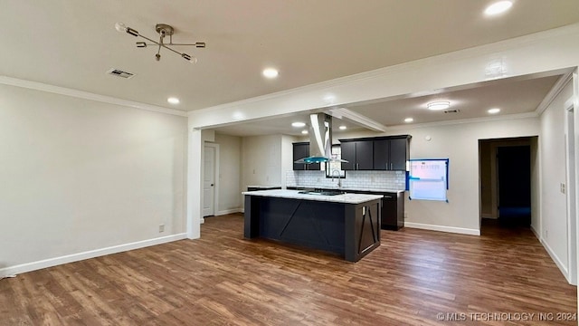 kitchen with dark hardwood / wood-style flooring, island range hood, a center island, and crown molding