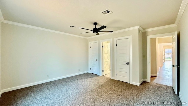 unfurnished bedroom featuring carpet flooring, crown molding, and ceiling fan